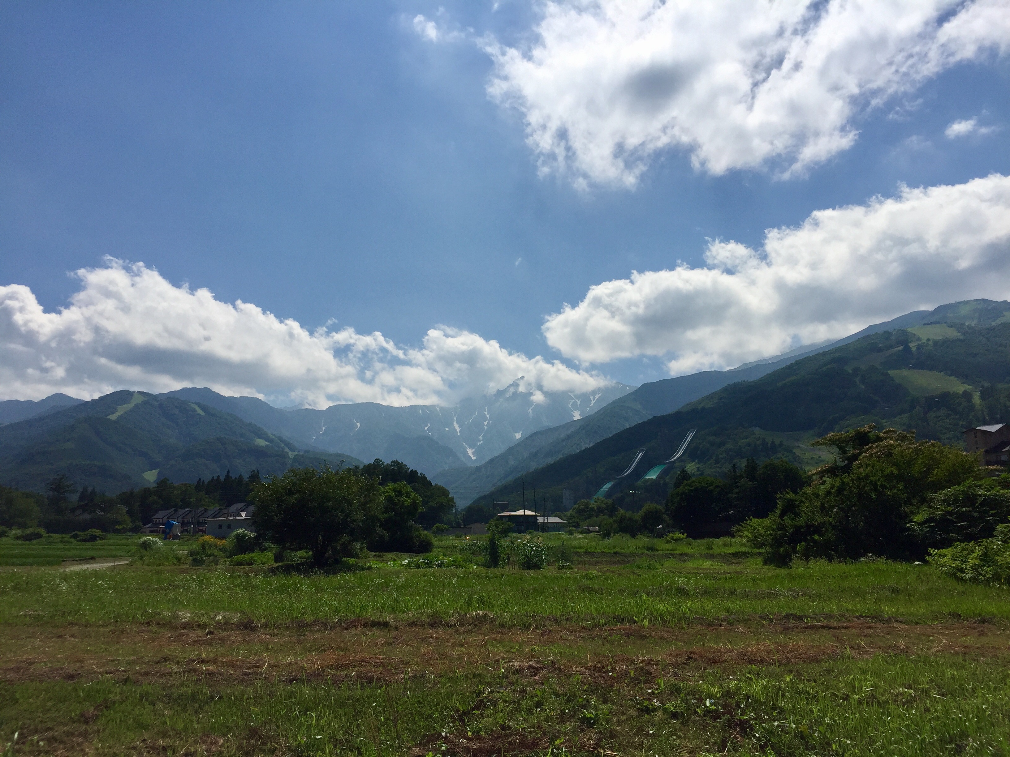 Green fields and mountain slopes above Hakuba village